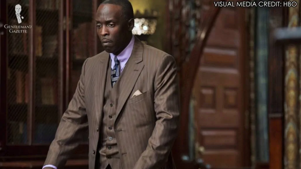 Chalky White in a brown three-piece striped suit