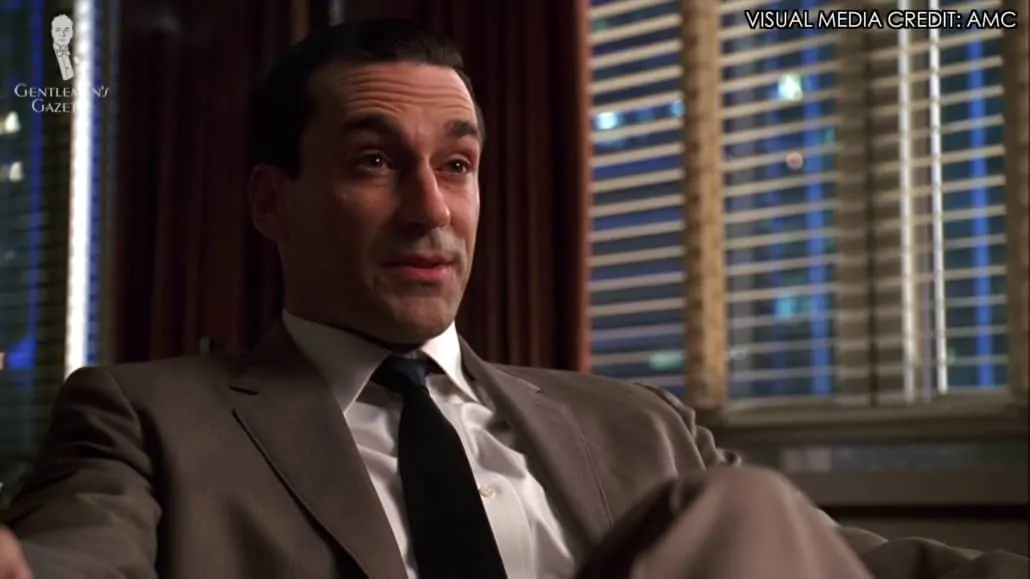 Don Draper in a two-piece suit and a slim tie