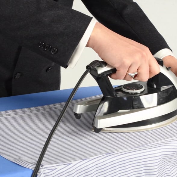 Raphael ironing a shirt