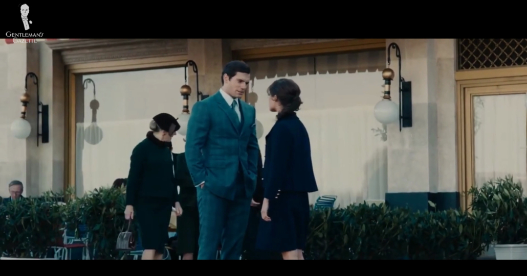 Henry Cavill as CIA agent Napoleon Solo, in a gray-blue suit with a large overcheck