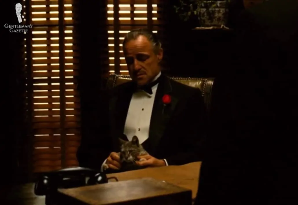 Don Vito Corleone, head of the Corleone family, wearing a black-tie outfit.