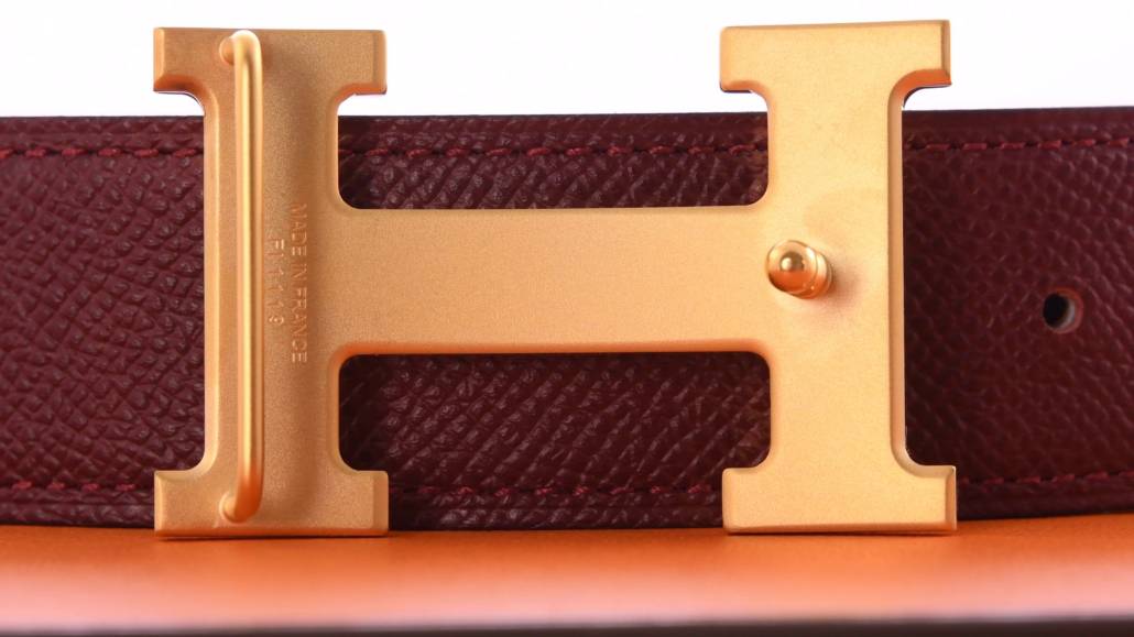 The reverse of a modern Hermes buckle with signature engraving.
