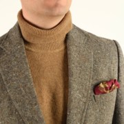 A silk-wool pocket square with an animal motif paired with a tweed jacket and a turtleneck sweater.