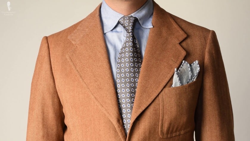 Brown Donegal tweed sport coat, blue-collared shirt and accessories with shades of blue from Fort Belvedere