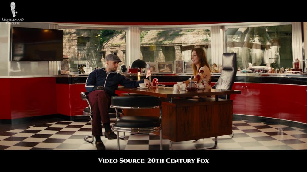 Charlie Hesketh wearing a navy crew neck puffer jacket, maroon chinos and a flat cap.