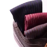 Fort Belvedere Shadow Striped socks in three colorways sit inside a dress shoe