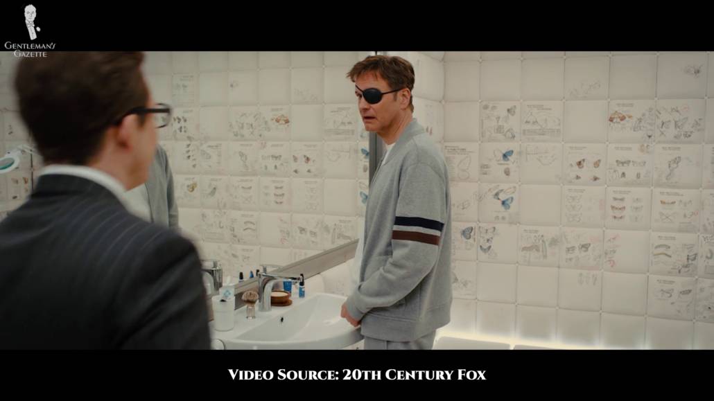 An amnesiac Harry wearing a sporty grey zip-up, plain white t-shirt, track pants, and an eye patch.