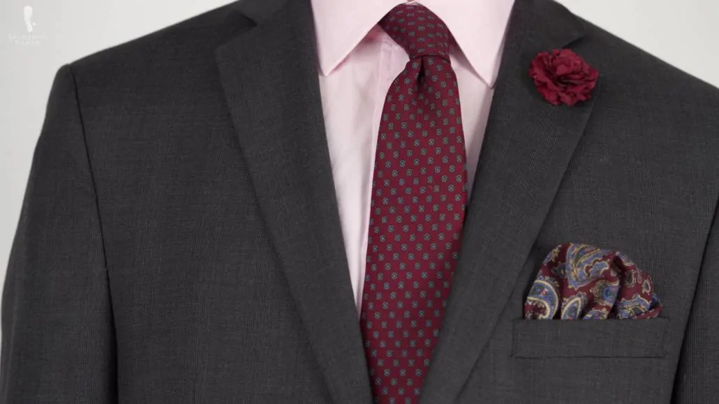 You can pair your gray suit with red accessories like a red tie and a pocket square with red tones in it.