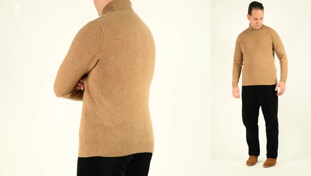 Raphael wearing a tan turtleneck sweater, black trouser, and brown suede leather shoes