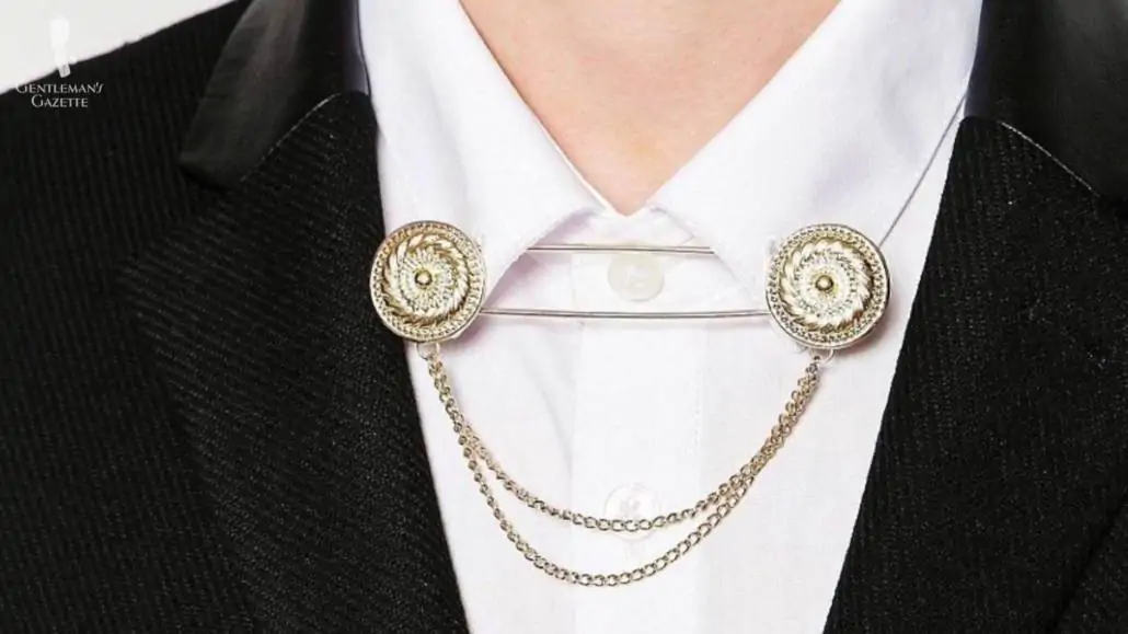 Light gold collar chains attached to a wingtip collar