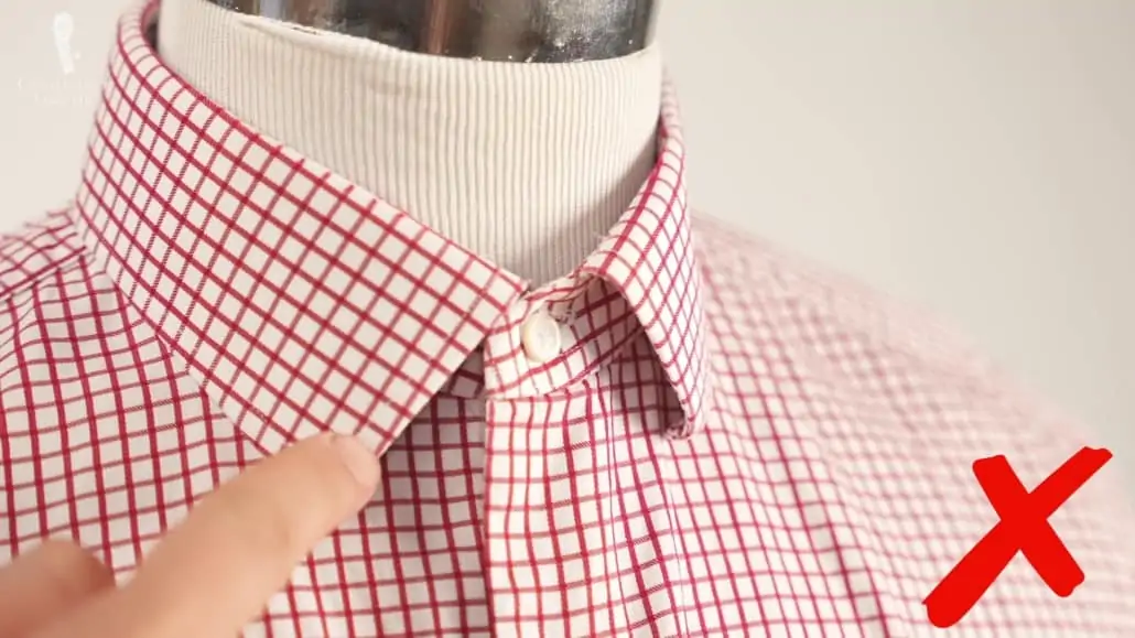 A curled collar tips is a hallmark of a cheaply or not thoughtfully-made shirt collar.