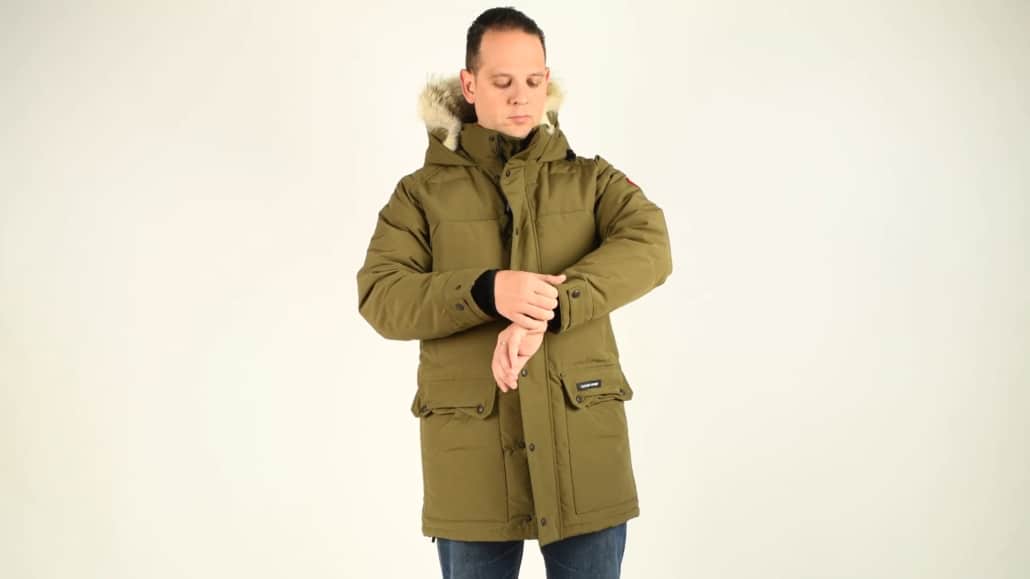 Raphael in an olive green Canada Goose emery slim fit parka and denim blue jeans. 