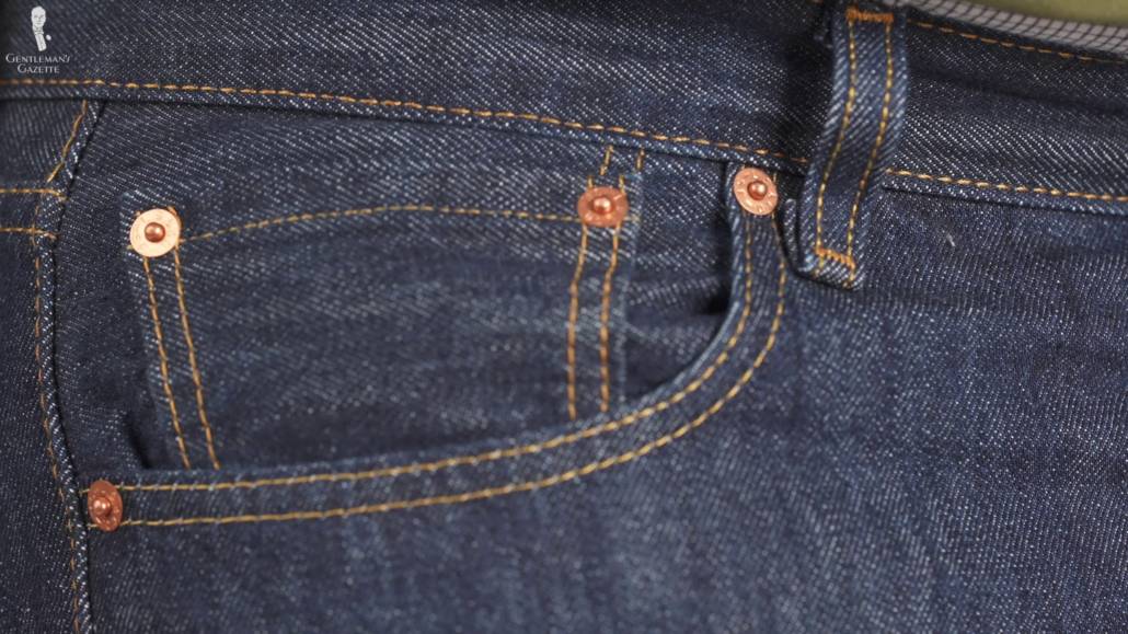 Levi's 501 dark wash rinsed jeans with copper rivets with the image zoomed in on the smaller right pocket