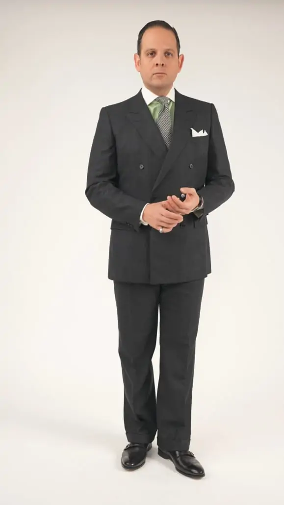 Raphael wearing a double breasted suit, white pocket square, green dress shirt with a white Winchester club collar, and black oxfords.