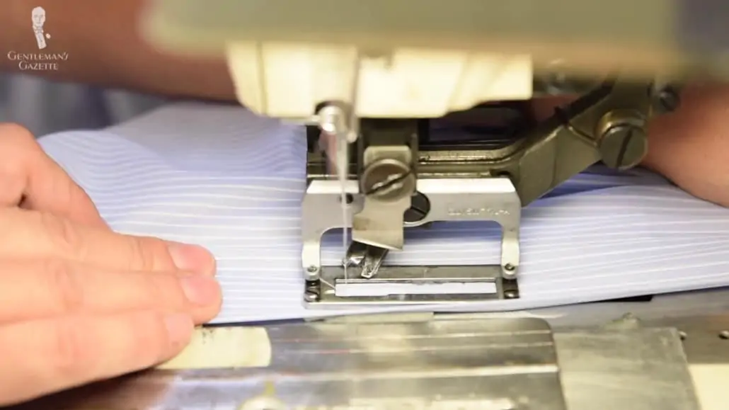 Machine stitching a light blue dress shirt