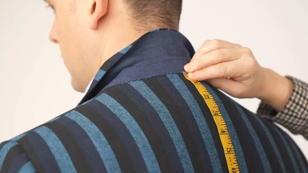 Measuring jacket length from top of the spine where the collar would sit