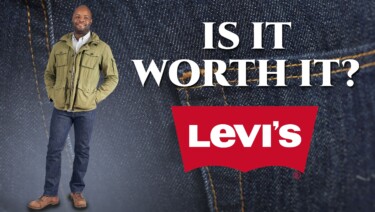 Levi's 501 rear shot with Kyle in the background wearing a green jacket, dark rinse 501 jeans, and brown Red Wing boots.