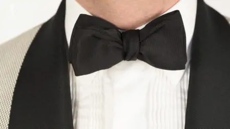 Raphael wearing a batwing bowtie with a ribbed tuxedo shirt.