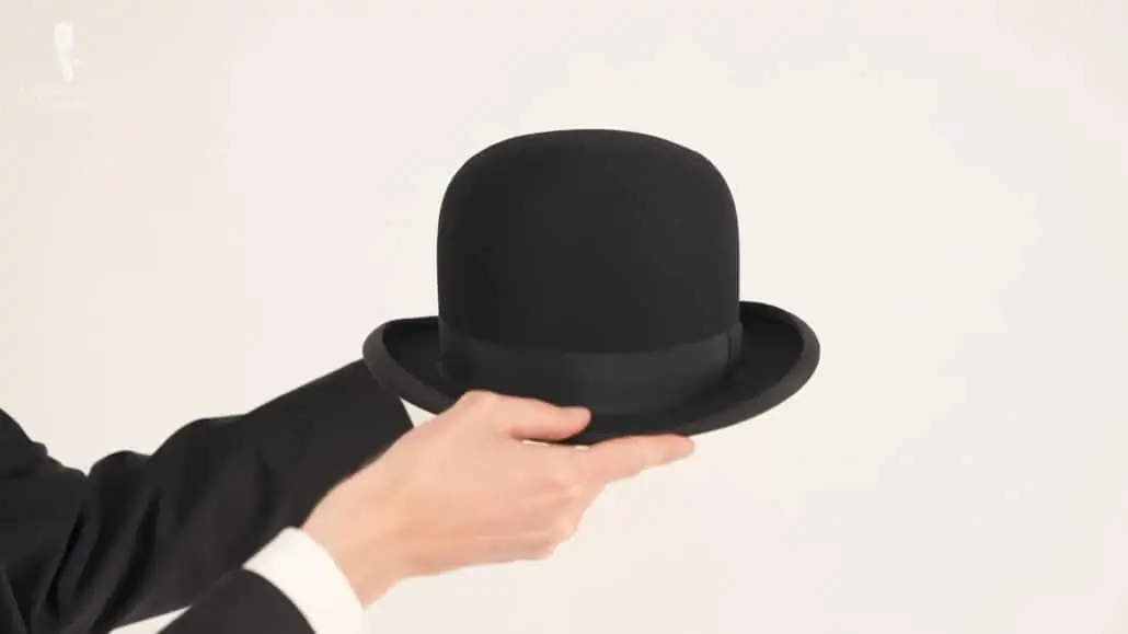Preston showing the brim of a black bowler hat with a black band.