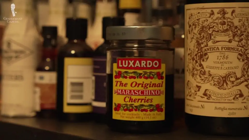 A bottle of Luxardo Maraschino Cherries along with other cocktail items
