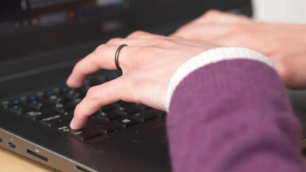 Preston typing on a laptop keyboard.