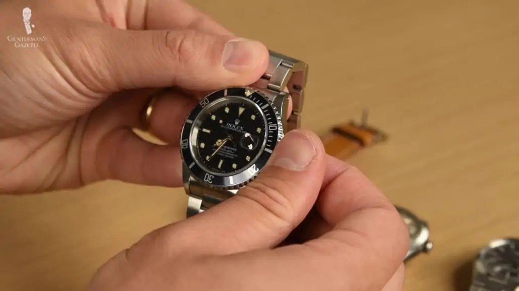 Raphael adjusting the time settings of a Rolex Sportswatch