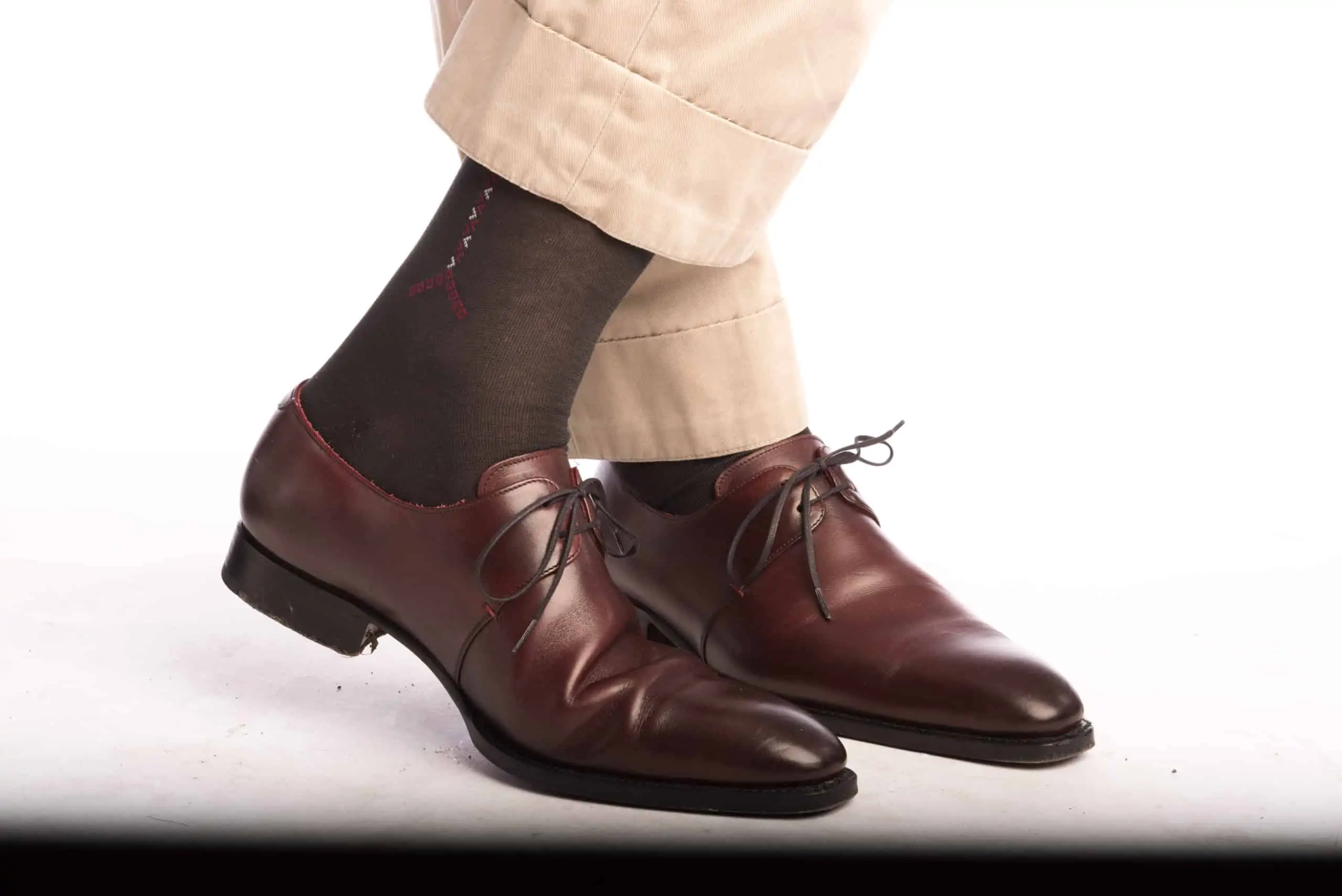 Khaki chinos paired with dark grey socks with burgundy and white clocks from Fort Belvedere and oxblood oxfords