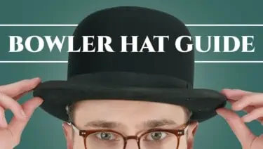 Preston wearing a black bowler hat brown eyeglasses.