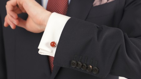 Suit sleeve with kissing buttons featuring a French cuff and red carnelian cufflinks