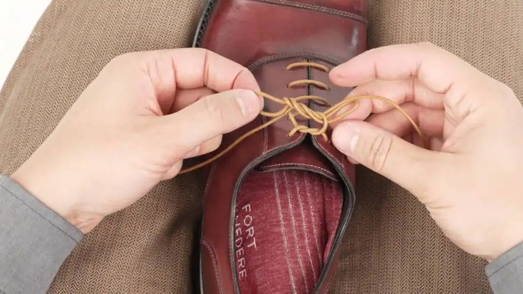 Raphael doing the Berluti knot on his shoelace.
