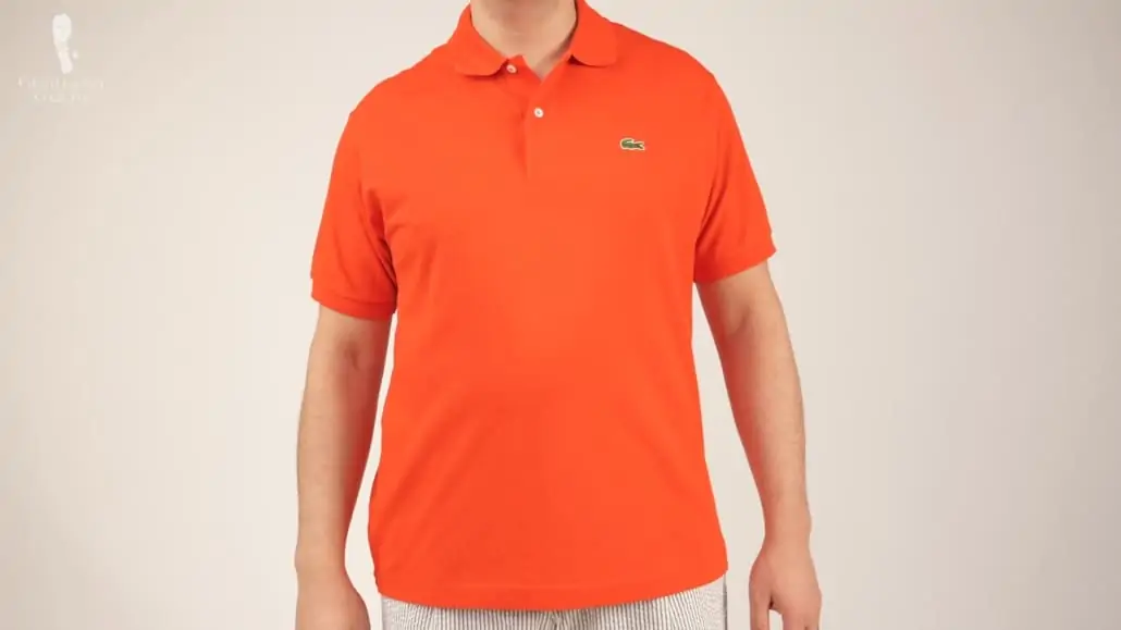 Raphael wearing an orange classic fit Lacoste shirt