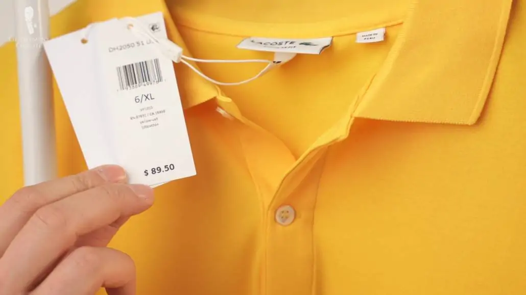 Raphael showing the price tag of a yellow Lacoste polo shirt in regular fit.