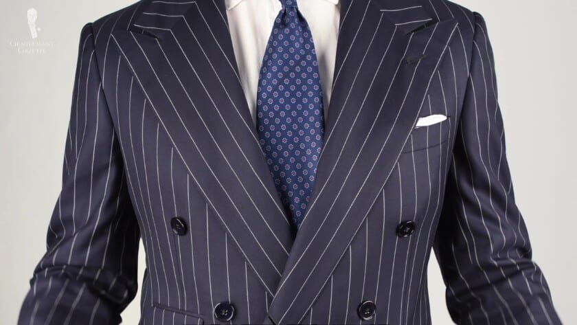 Navy blue pencil stripe suit with white dress shirt,madder silk tie with macclesfield pattern and white pocket square.