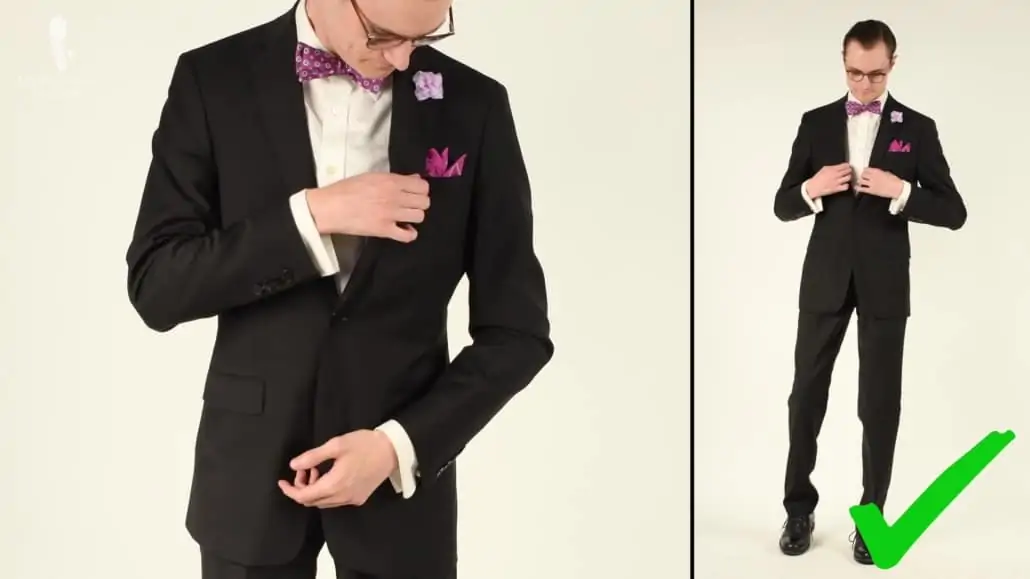 Preston wearing a black suit paired with pinkish/purple accessories. 