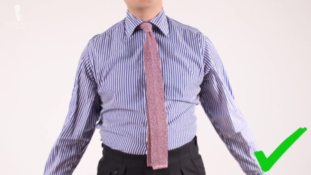 Raphael wearing a blue striped long sleeved dress shirt with pink mottled knit tie