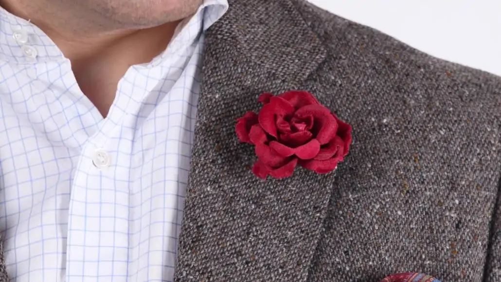 Red Spray Rose Boutonniere on a tweed jacket.