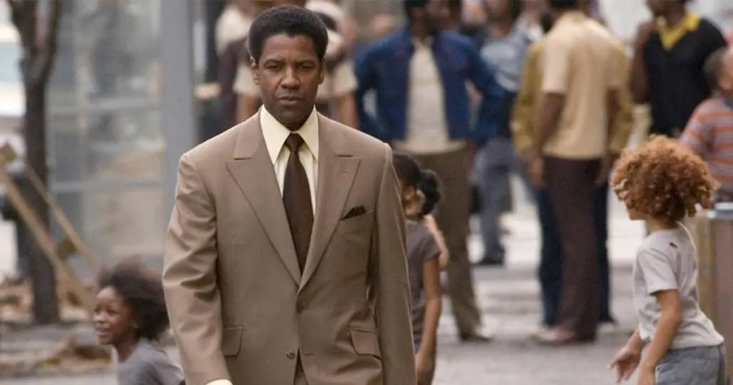 Denzel Washington wearing a brown suit with a brown tie.