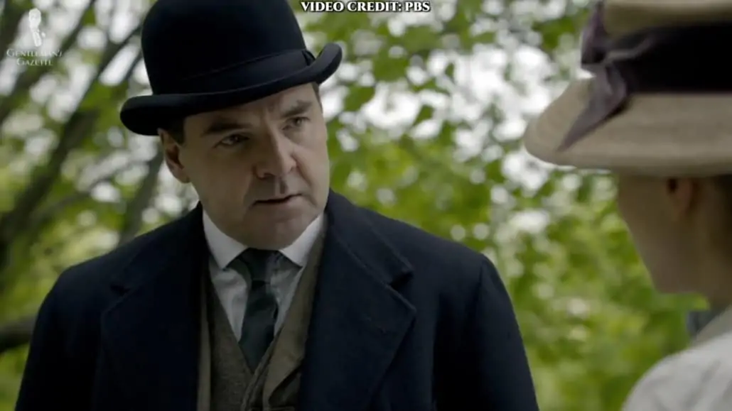 Mr. Bates' bowler hat is more modern in style, just like most bowlers in the show.