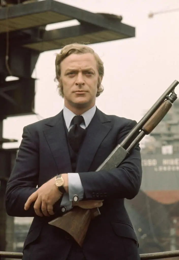 Michael Caine in a navy suit.