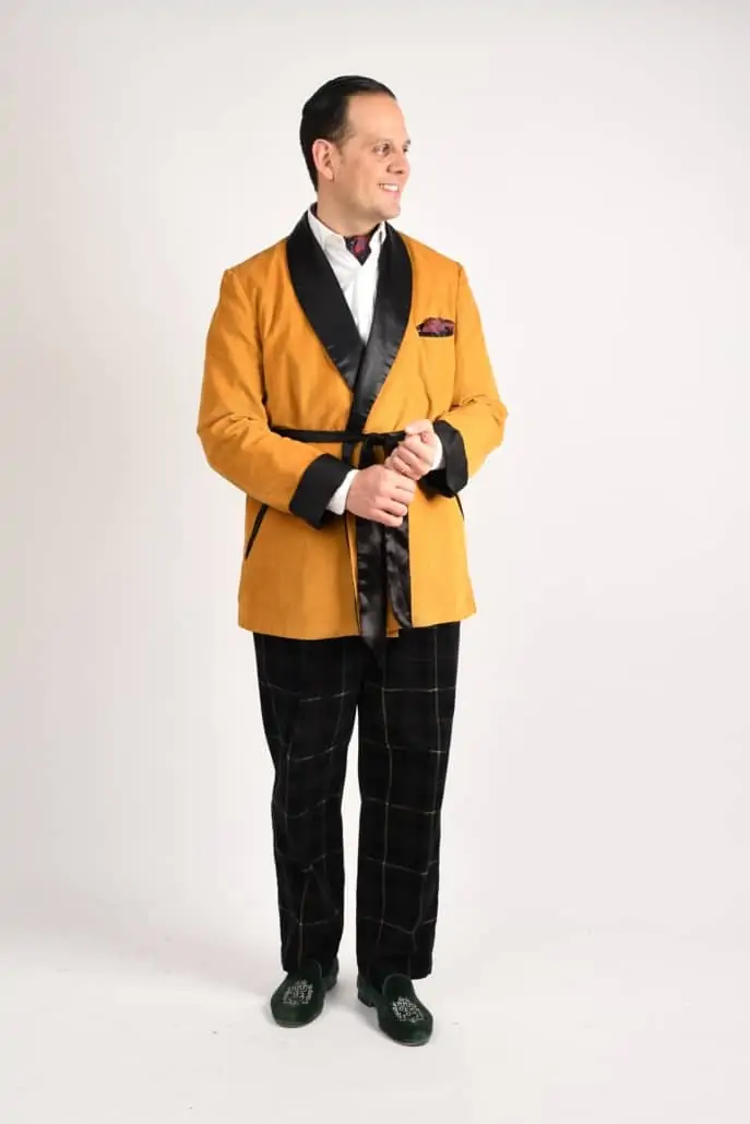 Raphael wearing a mustard yellow TV jacket and windowpane trousers