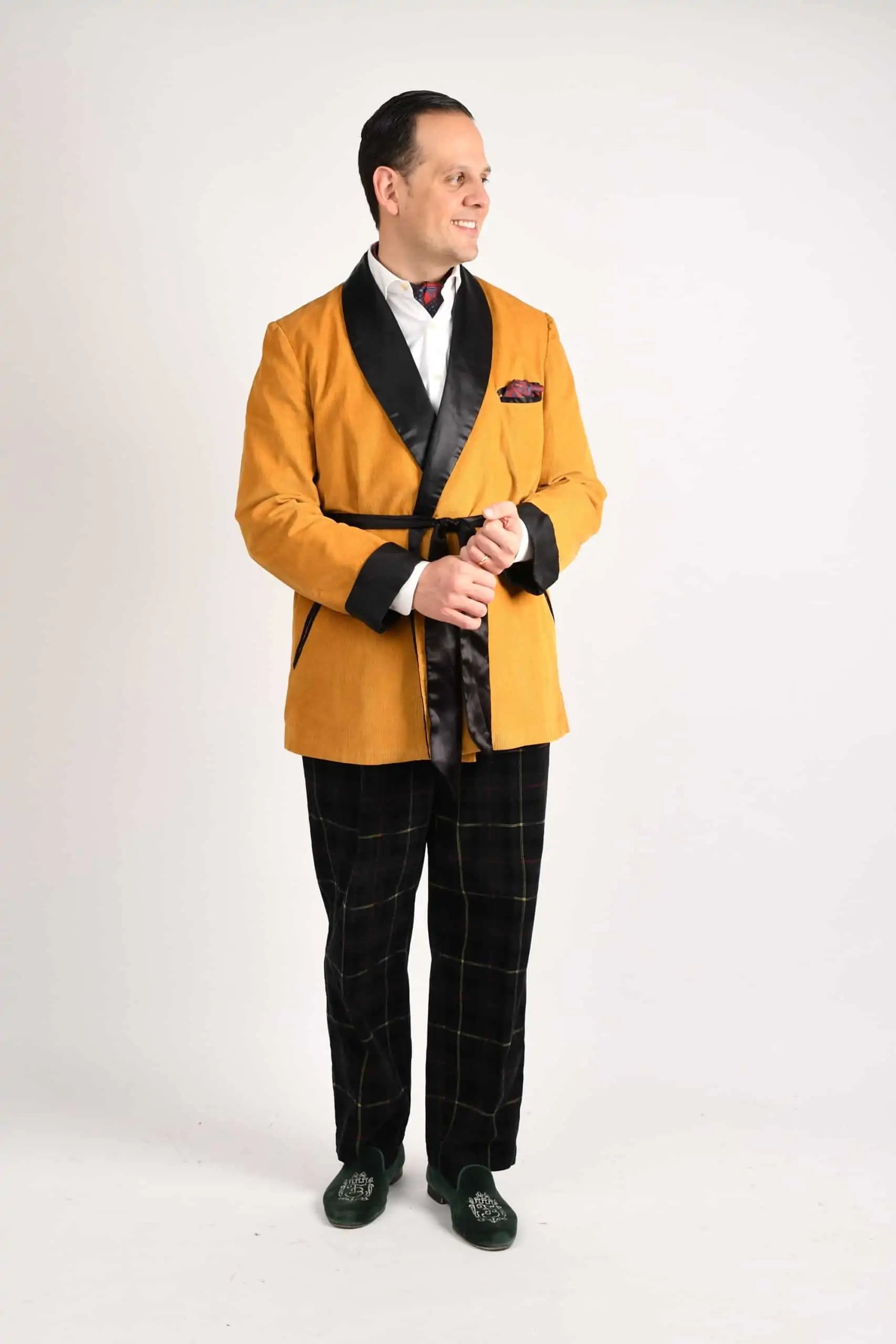 Raphael wearing a mustard yellow TV jacket and corduroy trousers