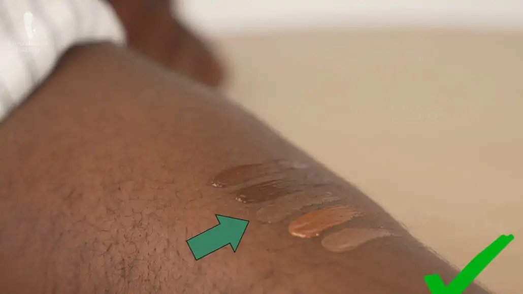 Here, the liquid concealer in the center is the best match for Kyle's skin.