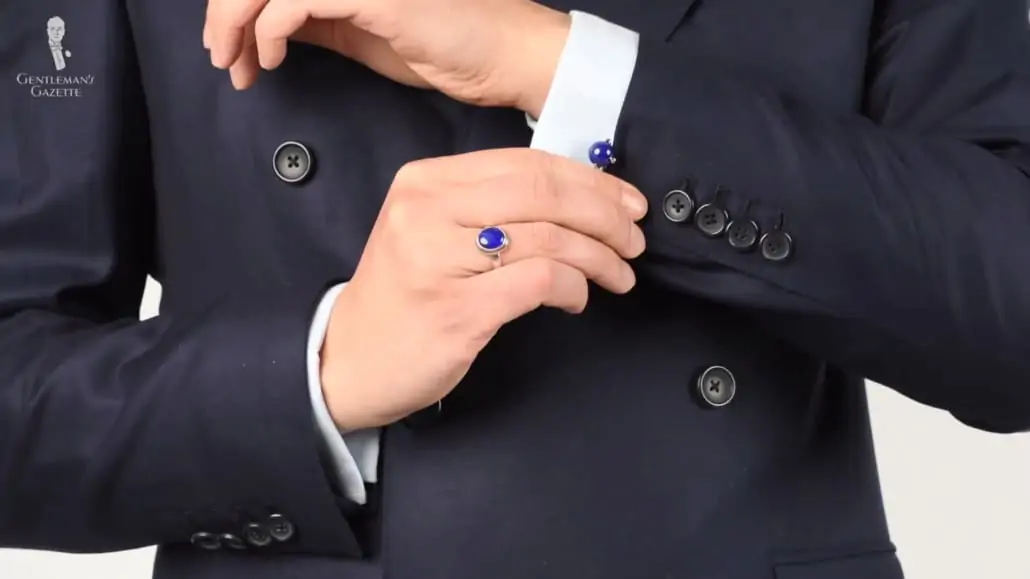 Navy suit with lapis lazuli ring and cufflinks.