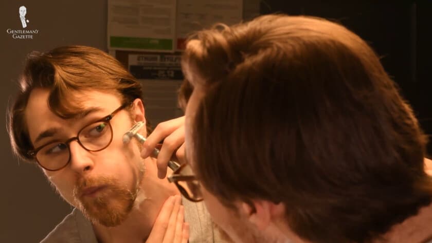 Preston shaving around his cheeks with a DE razor