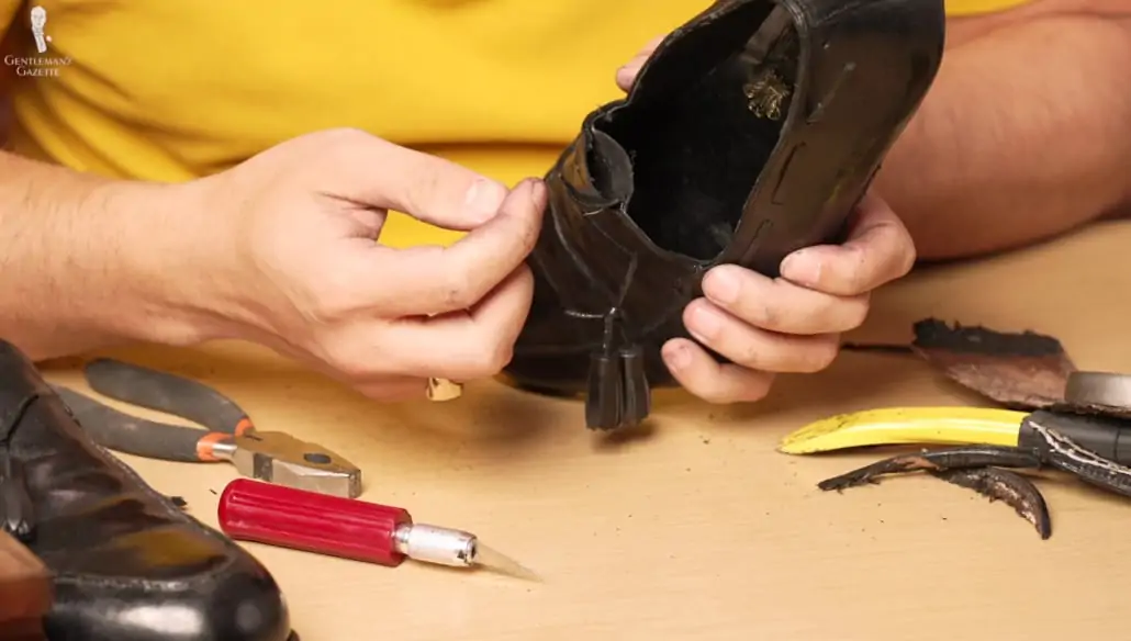 Raphael examines the stitching along the tongue of the bespoke Lobb loafers.