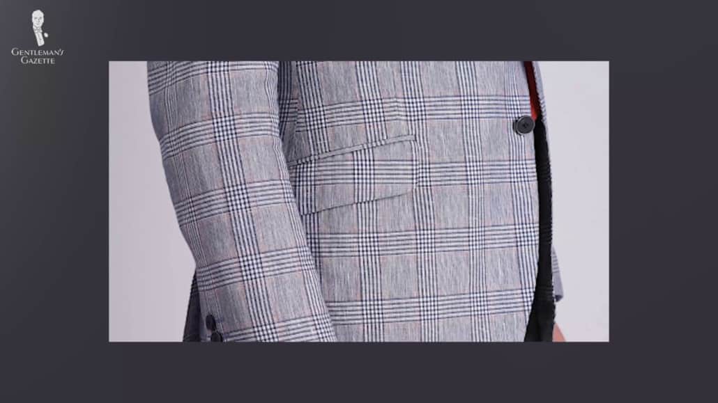 A flap pocket on a checked suit.