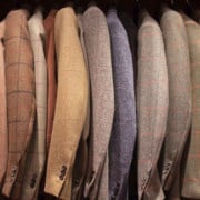 A rack of tweed jackets. A rack of tweed jackets.