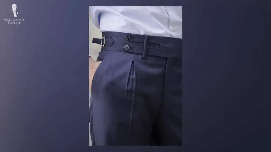 A vertical pocket on a dark navy trouser.