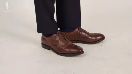 Cap-toed Oxfords in a dark brown color.