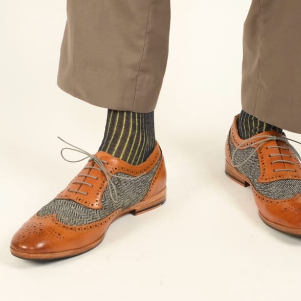 Goodyear welted brogue Strange Island shoes paired with a yellow and gray shadow striped socks from Fort Belvedere
